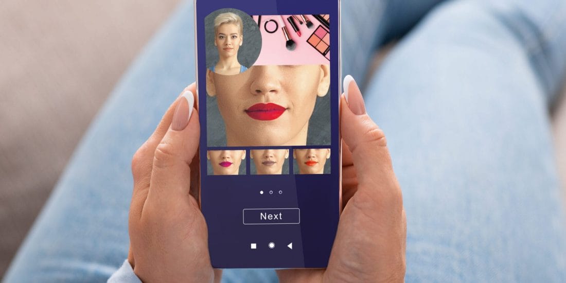 Extended Augmented Reality AI Beauty App. Woman Trying Different Lipstick Color Makeup On Smartphone